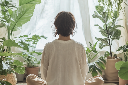 Person mediating in a room filled with natural light